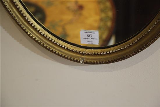 A pair of George III giltwood and gesso oval wall mirrors, W.1ft 5in. H.2ft 7.5in.